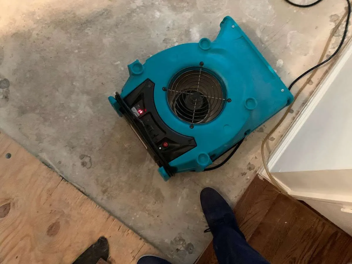 Air mover drying subfloor during Commercial Water Damage Restoration in Monticello